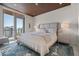 Serene bedroom features a comfortable bed, modern nightstands, and a private balcony with city views at 111 Golden Gate Pt # 802Ph, Sarasota, FL 34236