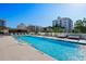 Inviting pool area with lounge chairs and cabanas, providing a luxurious outdoor experience for residents at 111 Golden Gate Pt # 802Ph, Sarasota, FL 34236