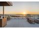 Inviting rooftop deck showcasing sunset views, dining area, and relaxing waterfront ambiance at 111 Golden Gate Pt # 802Ph, Sarasota, FL 34236