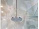 Close up of the overhead showerhead in the marble-look glass shower at 111 Golden Gate Pt # 802Ph, Sarasota, FL 34236