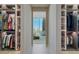 Spacious walk-in closet with custom shelving, drawers, and lighting at 111 Golden Gate Pt # 802Ph, Sarasota, FL 34236