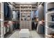 Walk-in closet with custom shelving, drawers, and ample storage space at 111 Golden Gate Pt # 802Ph, Sarasota, FL 34236