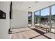 Serene yoga room with hardwood floors, floor-to-ceiling windows, and a view of the outdoor area at 111 Golden Gate Pt # 802Ph, Sarasota, FL 34236