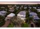 Aerial view of the property showing the exterior elevation and lush surroundings at sunset at 113 Maple Ave, Anna Maria, FL 34216