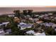 Aerial view of a lovely home nestled in a residential area near the beach with lush greenery at 113 Maple Ave, Anna Maria, FL 34216