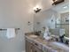 Bathroom featuring double sinks, granite countertops, and ample lighting at 113 Maple Ave, Anna Maria, FL 34216