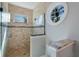 Modern bathroom featuring a glass enclosed shower with a unique round window at 113 Maple Ave, Anna Maria, FL 34216