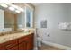 Well-lit bathroom featuring granite countertops and tile flooring near the toilet and shower at 113 Maple Ave, Anna Maria, FL 34216