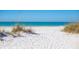 Serene beach scene with clear blue waters and soft white sand, perfect for relaxation and recreation at 113 Maple Ave, Anna Maria, FL 34216