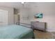 Comfortable bedroom featuring a dresser with a TV and an ensuite bathroom at 113 Maple Ave, Anna Maria, FL 34216