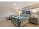 Comfortable bedroom with tile floors featuring an iron bed frame and window at 113 Maple Ave, Anna Maria, FL 34216