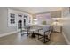 Bright bedroom with tile floors features French doors and two stylish chairs at 113 Maple Ave, Anna Maria, FL 34216