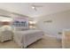 Bright bedroom with tile floors features a ceiling fan and white nightstands at 113 Maple Ave, Anna Maria, FL 34216