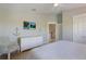 Bright bedroom featuring a decorative anchor, a white dresser, and a comfortable chair at 113 Maple Ave, Anna Maria, FL 34216