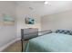 Relaxing bedroom showcasing a dresser with a TV and a comfortable chair at 113 Maple Ave, Anna Maria, FL 34216