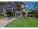 Charming two-story home with a well-manicured lawn and driveway at 113 Maple Ave, Anna Maria, FL 34216