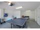 Spacious garage featuring a ping pong table and ample storage space for beach equipment at 113 Maple Ave, Anna Maria, FL 34216