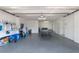 Spacious garage featuring a ping pong table and ample storage space for beach equipment at 113 Maple Ave, Anna Maria, FL 34216