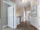 Well-lit hallway leading to various rooms with coastal-themed wall art and neutral walls at 113 Maple Ave, Anna Maria, FL 34216