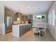Modern kitchen with stainless steel appliances, island, and adjacent dining area perfect for entertaining at 113 Maple Ave, Anna Maria, FL 34216