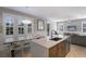 Bright and airy kitchen with white countertops, shutters, and eat-in area for casual dining at 113 Maple Ave, Anna Maria, FL 34216