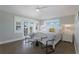 Bright and airy main bedroom with a white bed, bedside tables, and access to a balcony at 113 Maple Ave, Anna Maria, FL 34216