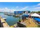Picturesque marina with docked boats, waterfront buildings, and a charming boardwalk area with scenic views at 113 Maple Ave, Anna Maria, FL 34216