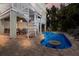 Home back exterior featuring a patio area and beautiful pool with a small table and spiral staircase at 113 Maple Ave, Anna Maria, FL 34216