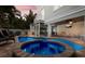 Beautiful backyard with a pool, spa, patio, outdoor grill and outdoor dining area at 113 Maple Ave, Anna Maria, FL 34216