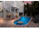 Home back exterior featuring a patio area and beautiful pool with a small table and spiral staircase at 113 Maple Ave, Anna Maria, FL 34216