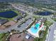 Aerial view showcasing community pool, playground, ponds, and lush landscaping in the neighborhood at 11847 Meadowgate Pl, Lakewood Ranch, FL 34211