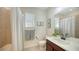 Well-lit bathroom features a shower/tub combination and a large mirror at 11847 Meadowgate Pl, Lakewood Ranch, FL 34211