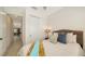 Comfortable bedroom with closet, lamp, and decorative pillows at 11847 Meadowgate Pl, Lakewood Ranch, FL 34211