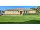 Charming home featuring a well-manicured lawn and a bright orange front door at 11847 Meadowgate Pl, Lakewood Ranch, FL 34211