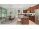 Modern kitchen featuring granite countertops, stainless steel appliances, and a dining area at 11847 Meadowgate Pl, Lakewood Ranch, FL 34211