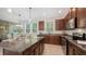 Well-lit kitchen features granite countertops, wooden cabinets, and stainless steel appliances at 11847 Meadowgate Pl, Lakewood Ranch, FL 34211