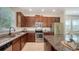Bright kitchen offers granite countertops, stainless steel appliances, and ample cabinet space at 11847 Meadowgate Pl, Lakewood Ranch, FL 34211