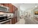 Kitchen with stainless steel appliances and granite countertops, leading into the living area at 11847 Meadowgate Pl, Lakewood Ranch, FL 34211