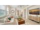 Bright living room featuring neutral furniture, tile flooring, and plenty of natural light at 11847 Meadowgate Pl, Lakewood Ranch, FL 34211
