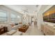 Bright living room featuring neutral furniture, tile flooring, and plenty of natural light at 11847 Meadowgate Pl, Lakewood Ranch, FL 34211