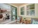 Cozy screened-in patio with seating area and easy access to the kitchen and living area at 11847 Meadowgate Pl, Lakewood Ranch, FL 34211