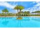 Tranquil community pool featuring a charming island in the center and ample space for residents to unwind and socialize at 11847 Meadowgate Pl, Lakewood Ranch, FL 34211