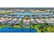 Aerial view of home showcasing pool, tile roof, and surrounding community by the water at 11913 Blue Hill Trl, Bradenton, FL 34211