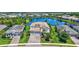 Aerial view of a home surrounded by a lake and other homes in the neighborhood at 11913 Blue Hill Trl, Bradenton, FL 34211