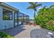 Outdoor patio space with a screened-in porch, firepit, and view of the pool and the lake at 11913 Blue Hill Trl, Bradenton, FL 34211