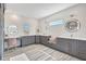 Stylish bathroom with double vanity, modern light fixtures, and elegant gray cabinetry at 11913 Blue Hill Trl, Bradenton, FL 34211