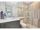 Modern bathroom features wood-look ceramic tile in shower, with glass divider, and quartz countertop at 11913 Blue Hill Trl, Bradenton, FL 34211