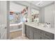 Hall bathroom with granite countertop and tile floor, adjacent to soccer-themed bedroom at 11913 Blue Hill Trl, Bradenton, FL 34211