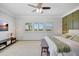 Spacious bedroom featuring a ceiling fan, accent wall, and natural light from three windows at 11913 Blue Hill Trl, Bradenton, FL 34211