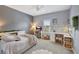 Cozy bedroom with a neutral color palette and a built-in storage unit under the bed and a desk at 11913 Blue Hill Trl, Bradenton, FL 34211